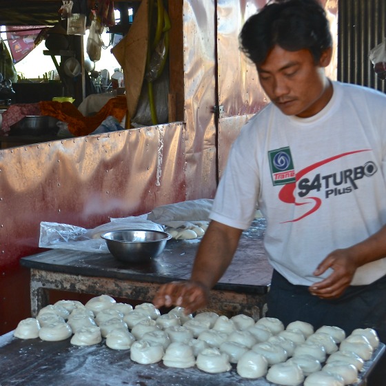 Preparing buns at the marketplace in Burma.