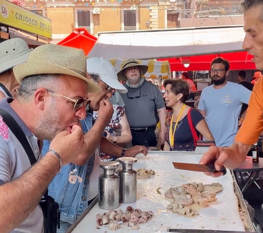 Man eating street food in Catania, Italy. 