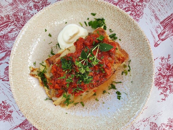 stuffed cabbage on red and white table cloth