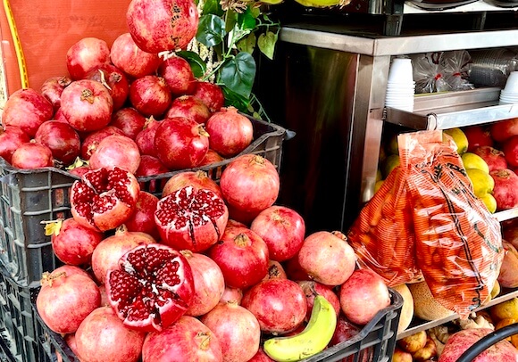 pile of pomegranate with street food stand