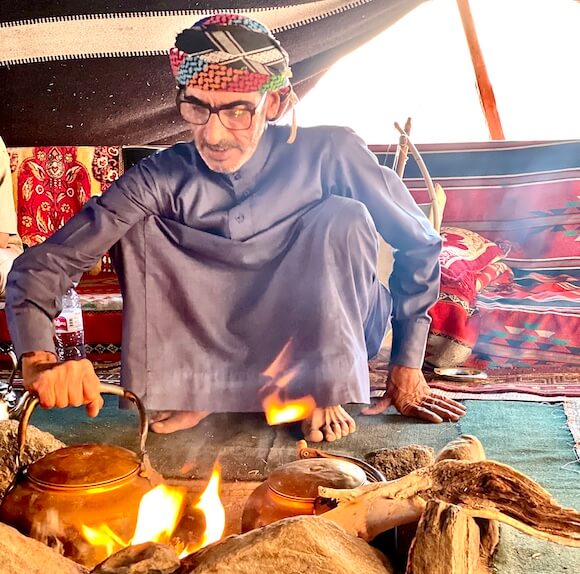 Bedouin man making tea in traditional Wadi Rum tent