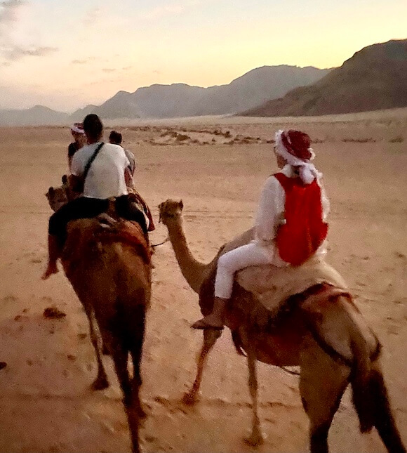 woman on camel in desert