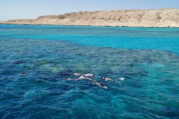 snorkeling in turquoise water in Egypt