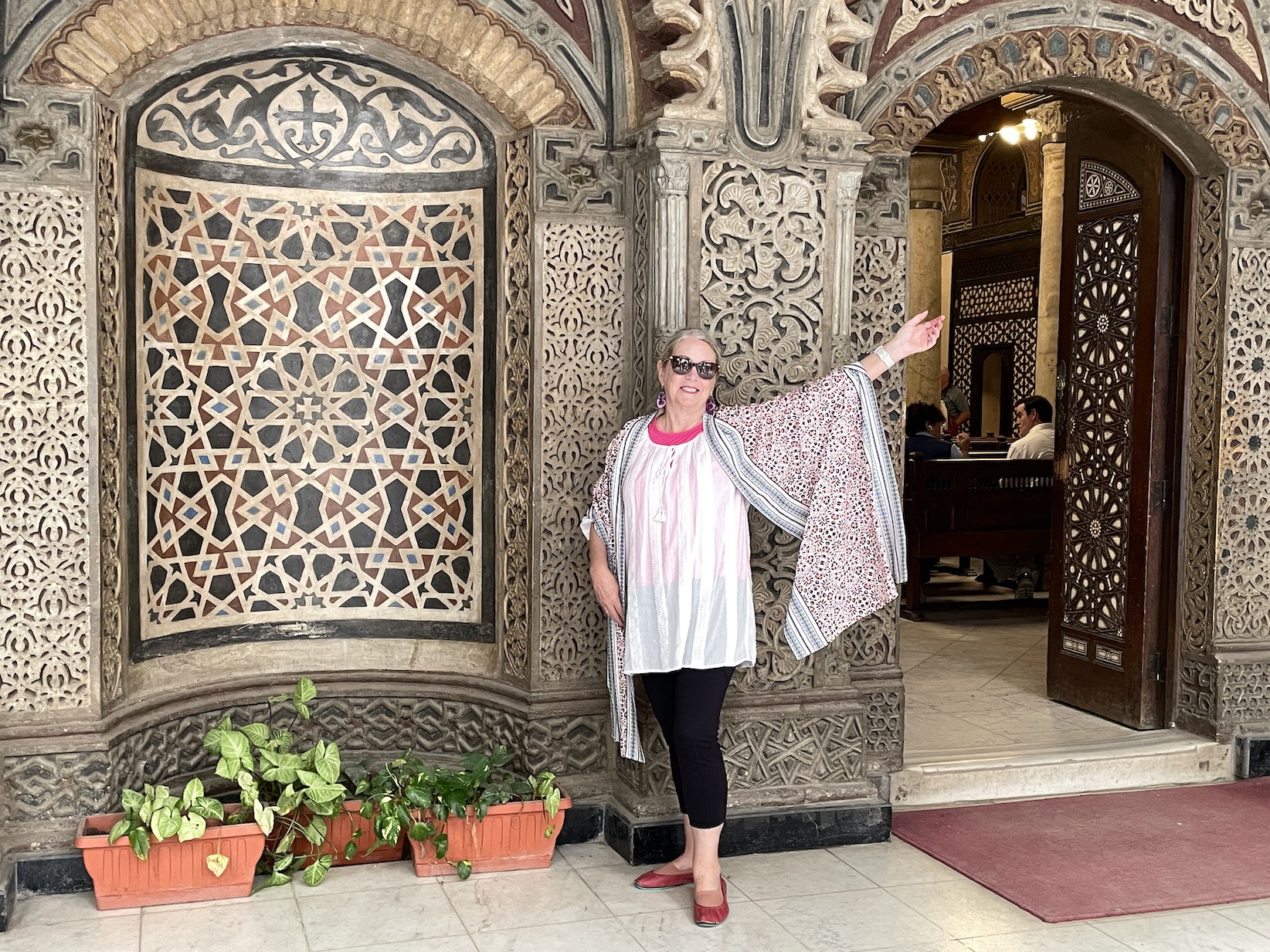 woman in front of mosaics at the Hanging Church in Cairo