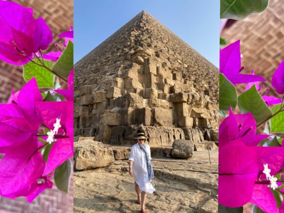 woman walking in front of Grand Pyramid with bougainvillea on each side