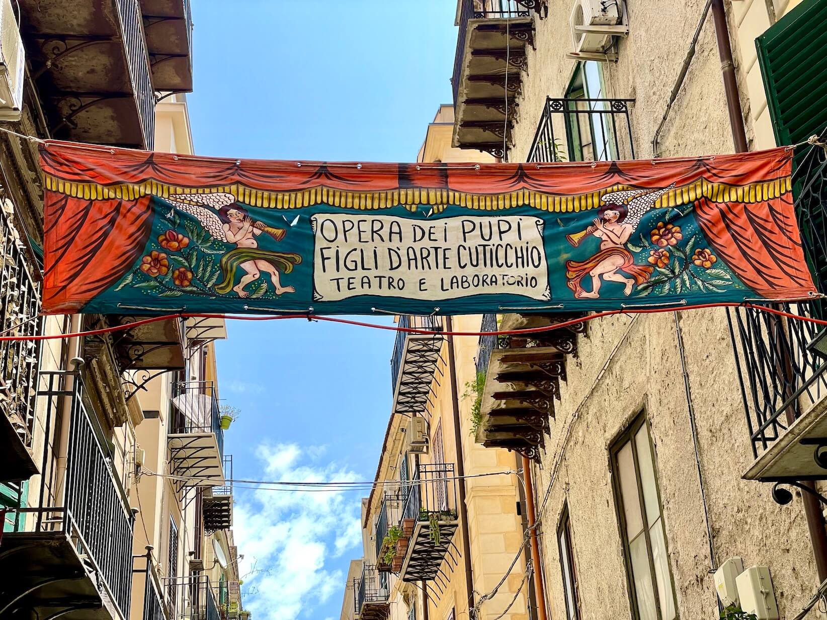 Street banner announcing puppet show in Palermo, Italy. 