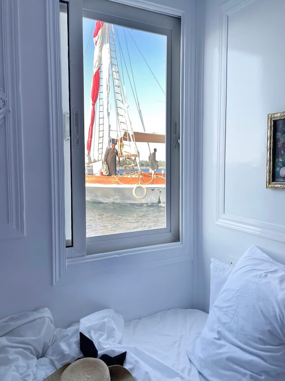 White stateroom dahabiya boat in window