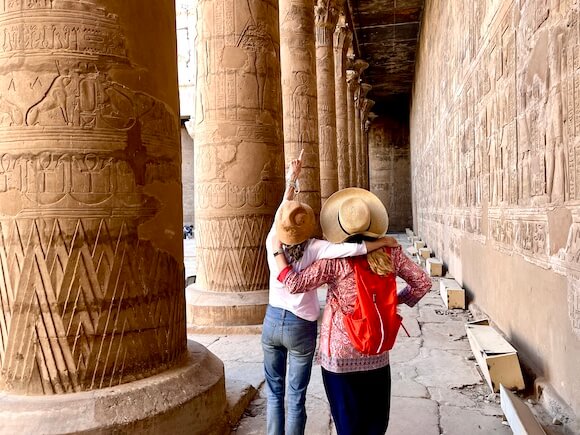 two women looking at pillars in Egypt